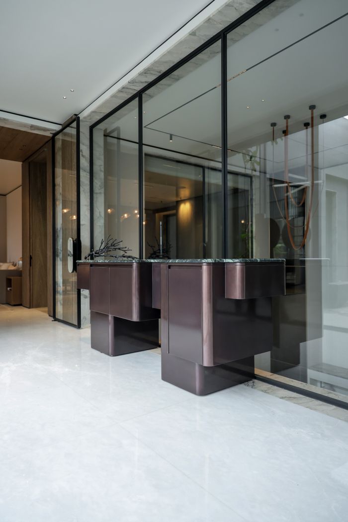 Contemporary luxury interior featuring sleek glass partitions and stylish minimalist design.